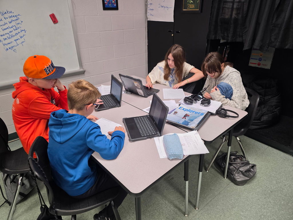 Students working in groups to complete an escape room activity. 