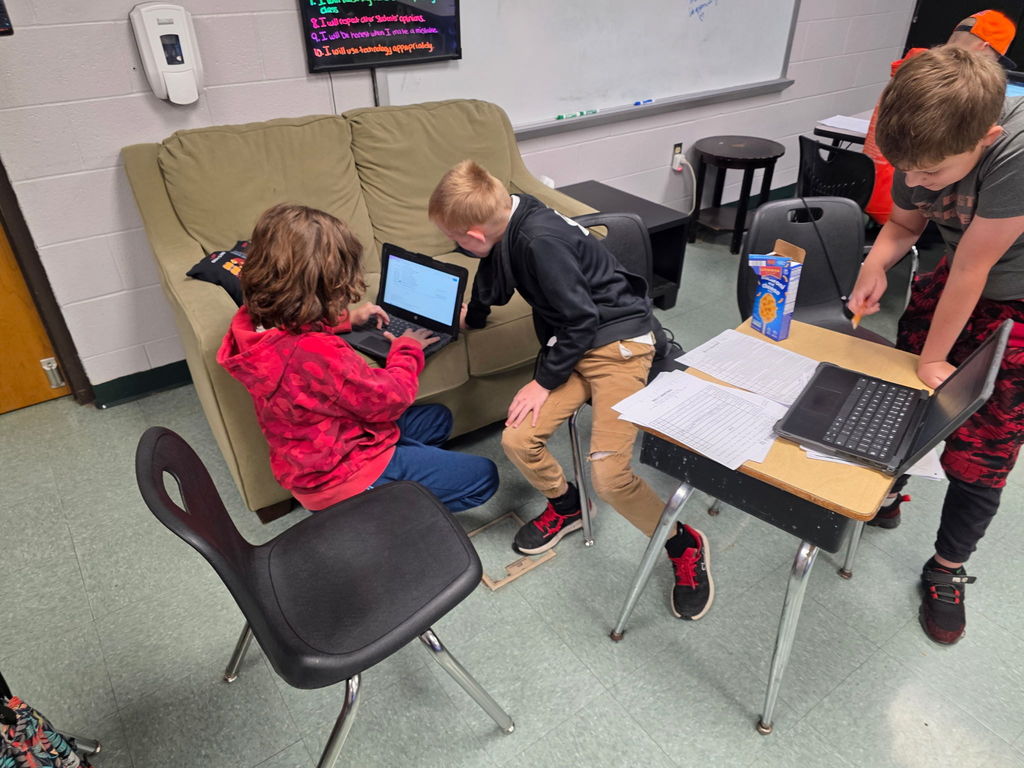 Students working in groups to complete an escape room activity. 