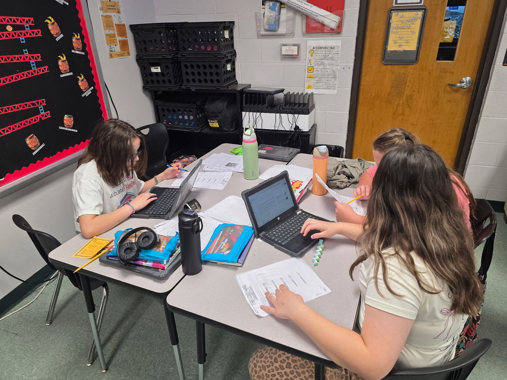 Students working in groups to complete an escape room activity. 