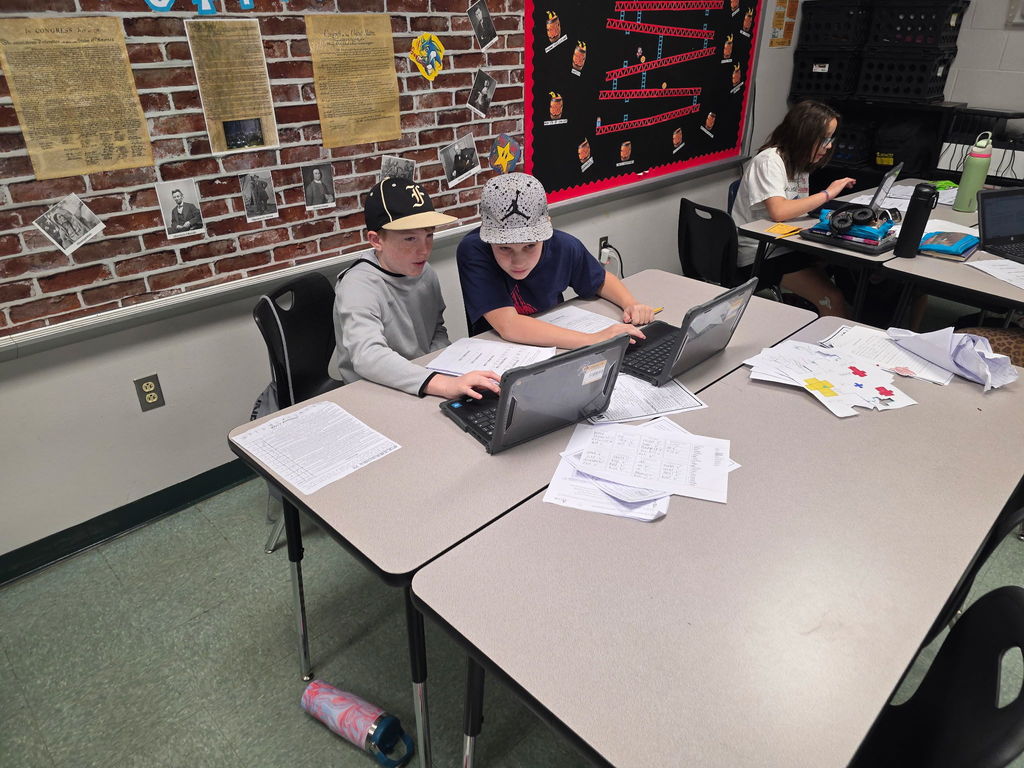 Students working in groups to complete an escape room activity. 