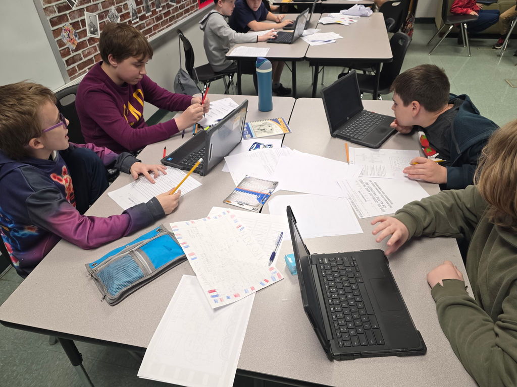 Students working in groups to complete an escape room activity. 