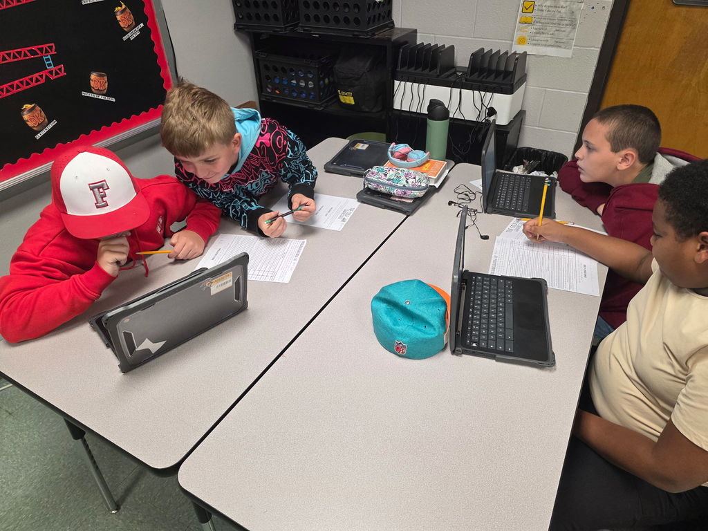 Students working in groups to complete an escape room activity. 