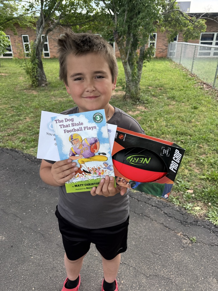 student with book and prize