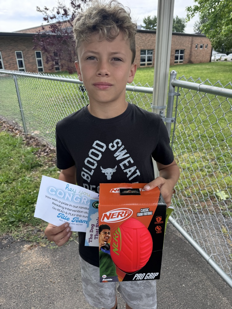 student with book and prize