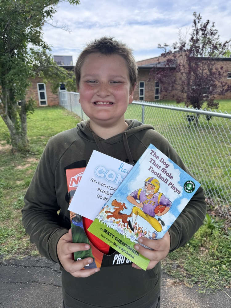 student with book and prize