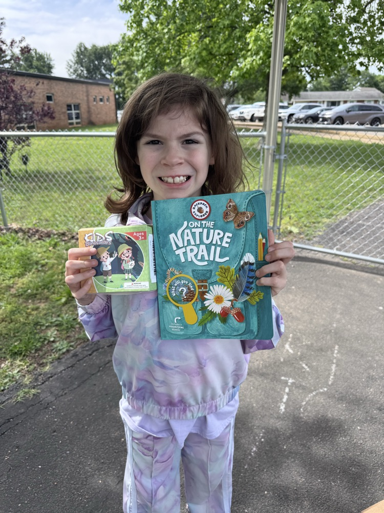 student with book and prize