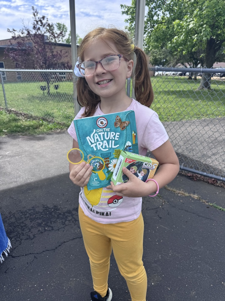 student with book and prize