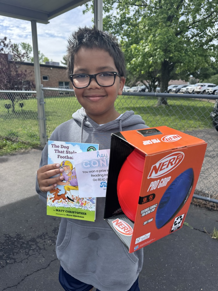 student with book and prize