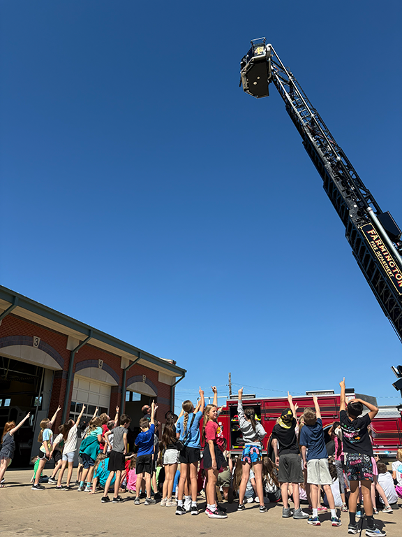 Students at the Farmington Fire Department with ladder
