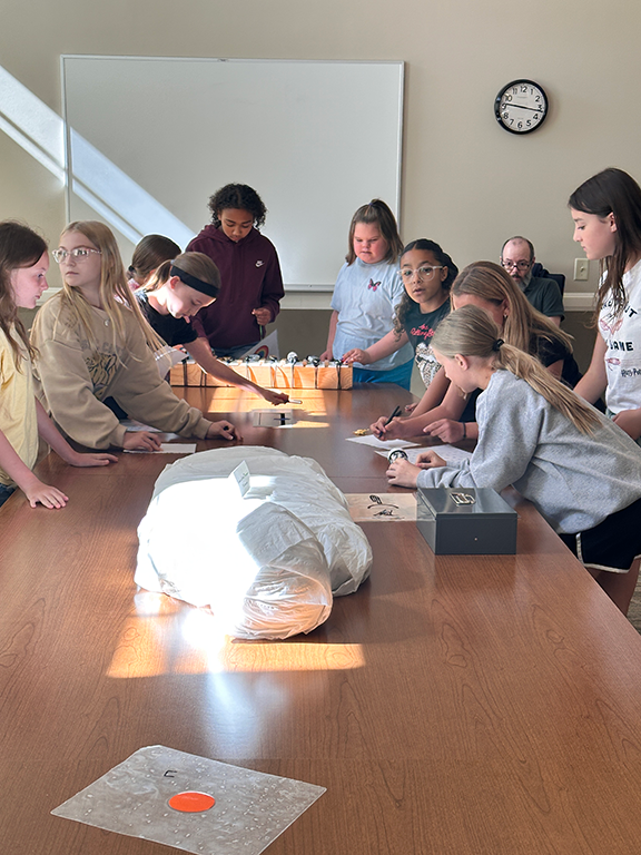 Kids working on escape room puzzles