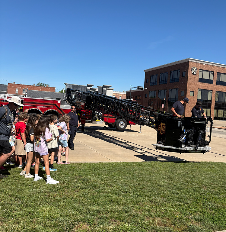 Students at Farmington Fire Department with ladder truck