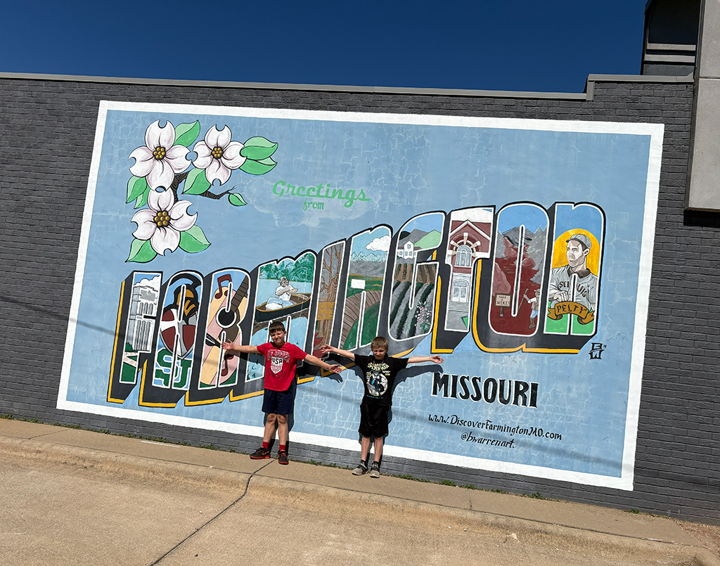 Kids in front of Farmington sign