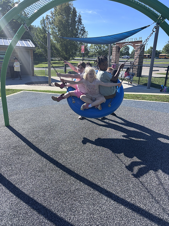 Kids playing on tire swing