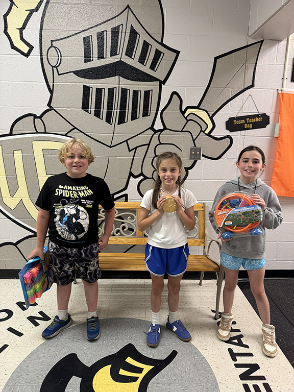 Students holding their reward for perfect attendance