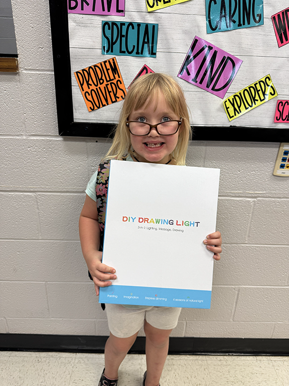 student holding a DIY Drawing Light