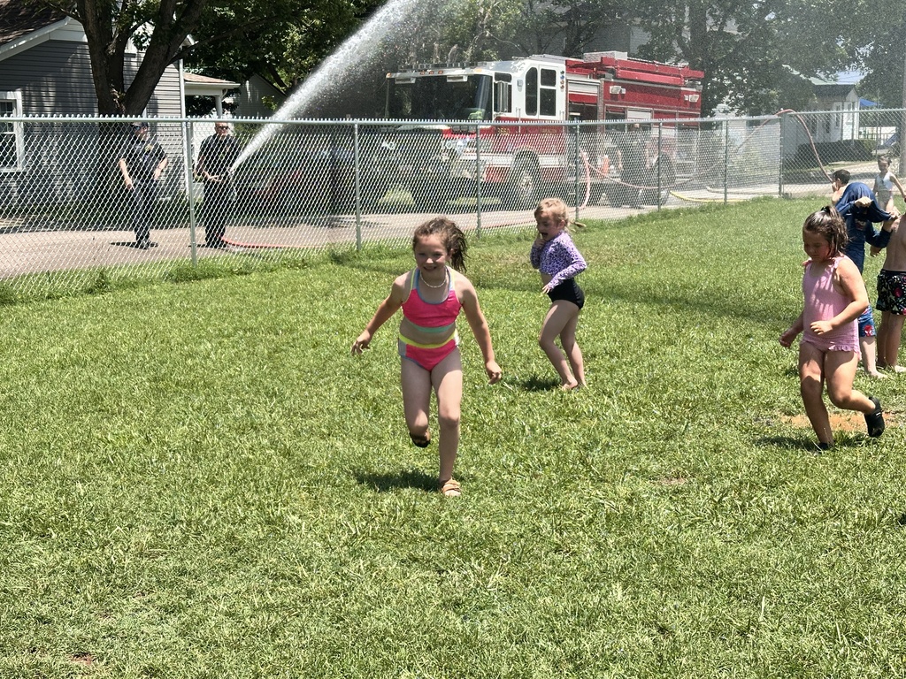 Kids getting sprayed by water