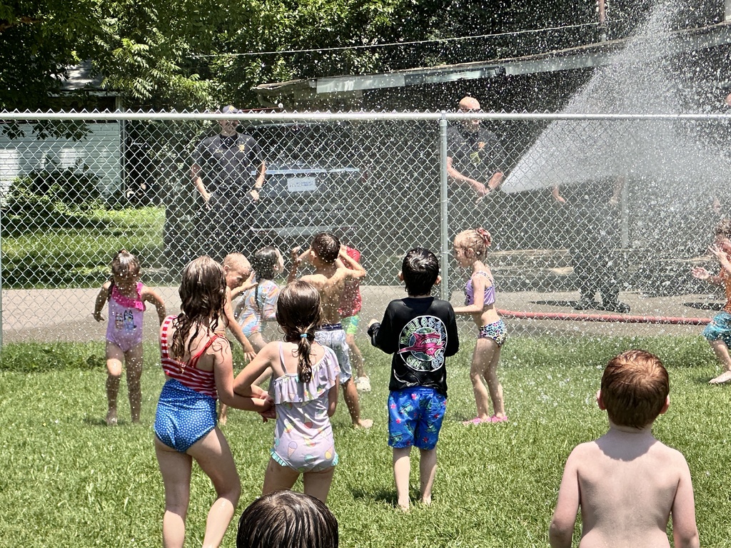 Kids getting sprayed by water