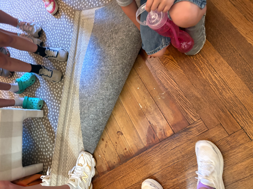 Kids in historic home looking at old floors