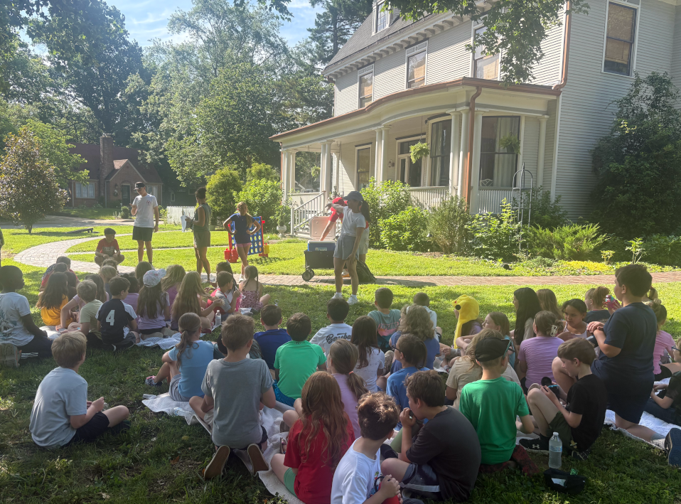 Kids listening to a speech at a historic home