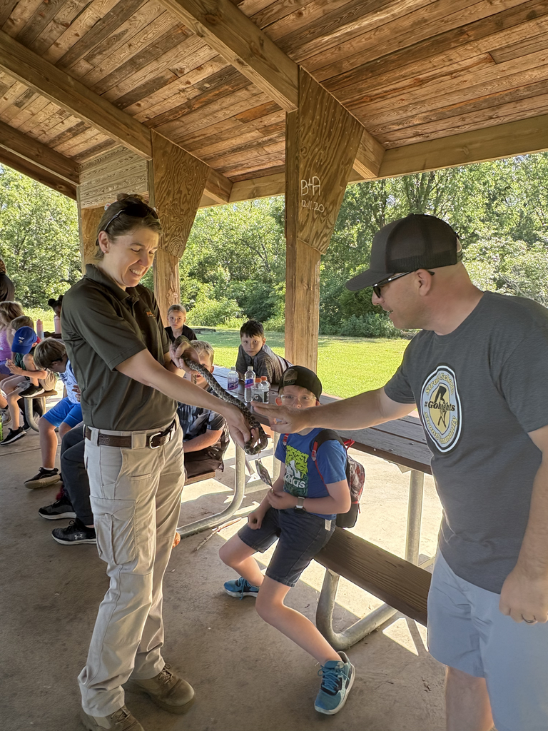 Kids at a park learning about snakes