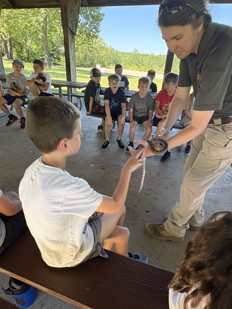 Kids at a park learning about snakes