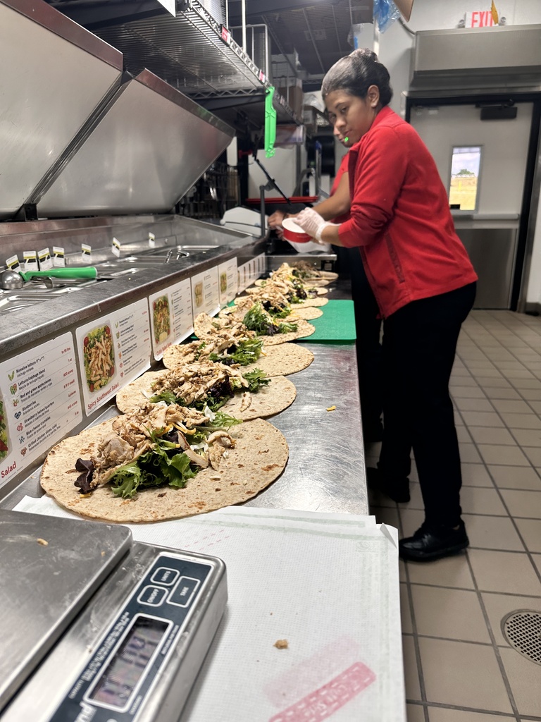Worker making chicken wraps