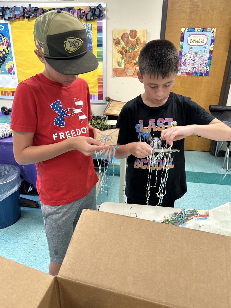 Boys weaving a bracelet