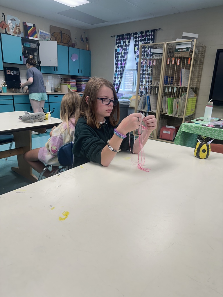 Girl weaving a bracelet