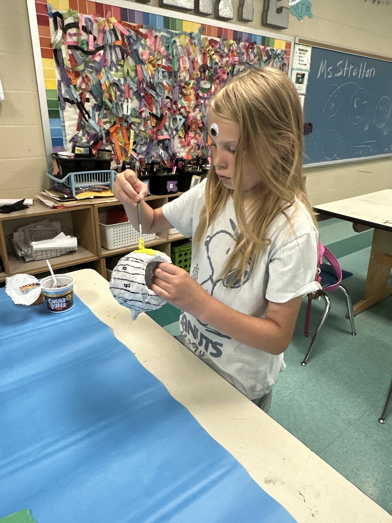 Girl painting a flower pot