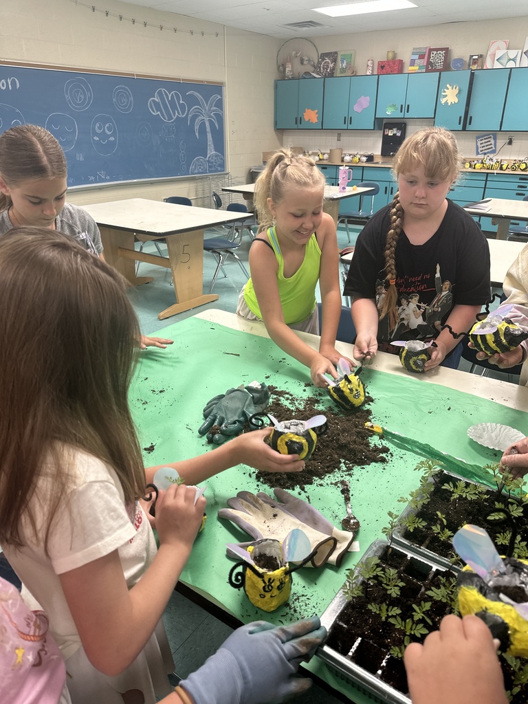 Kids filling flower pots with dirt