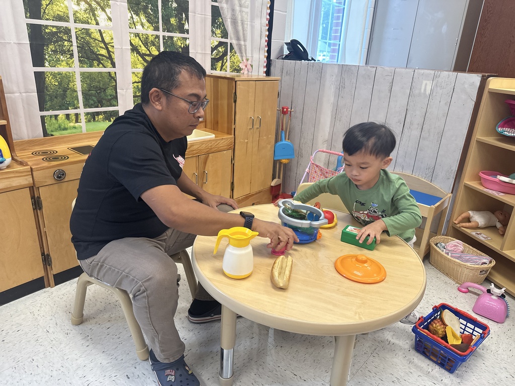 Man and boy at a table playing with crafts