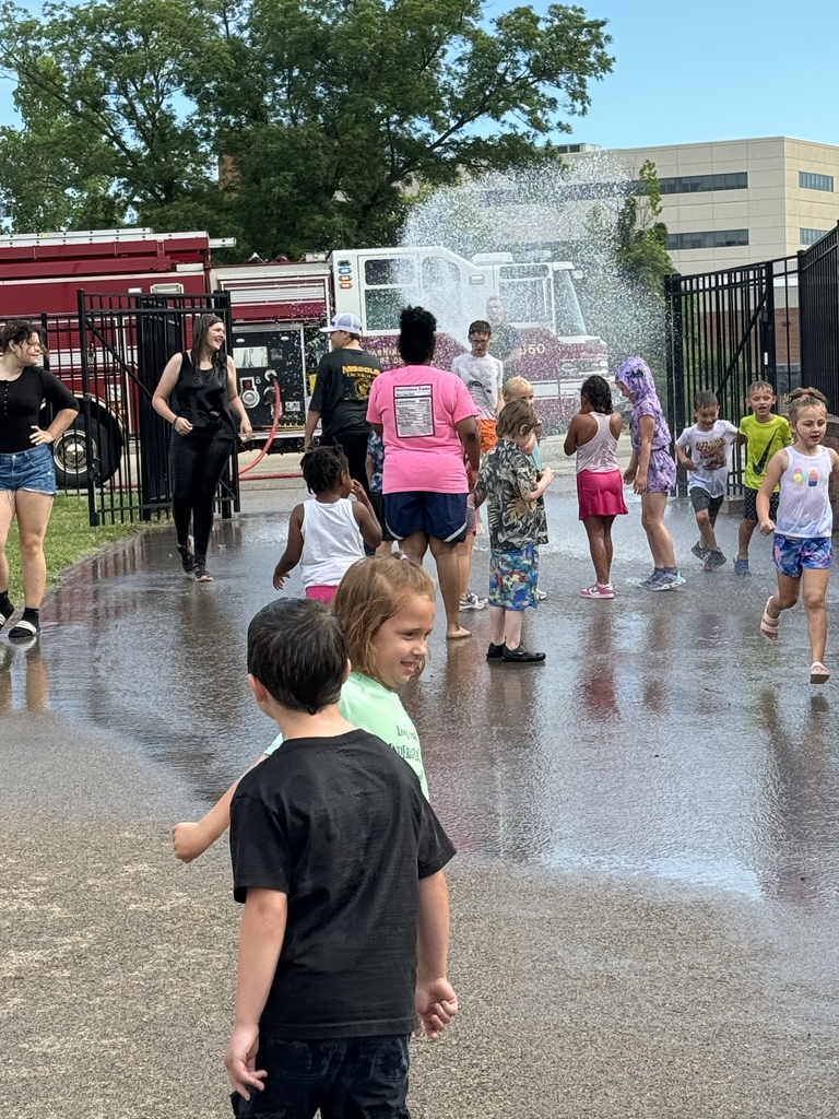 Fire truck spraying water in air for students