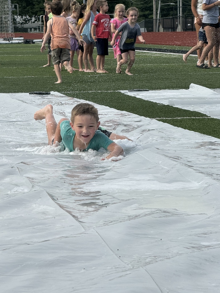 Kid sliding on water slide