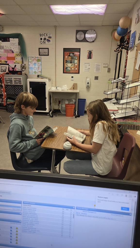 students reading books in classroom
