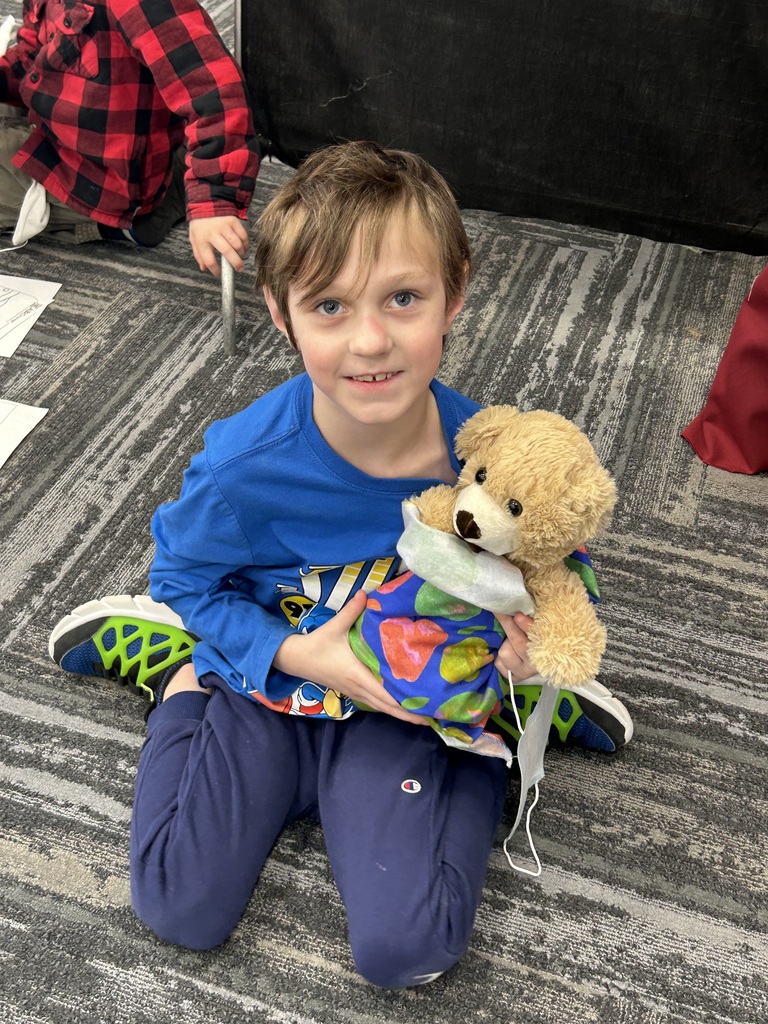 BOY HOLDING TEDDY BEAR AT AT CTE MAGNUS CENTER TEDDY BEAR CLINIC 