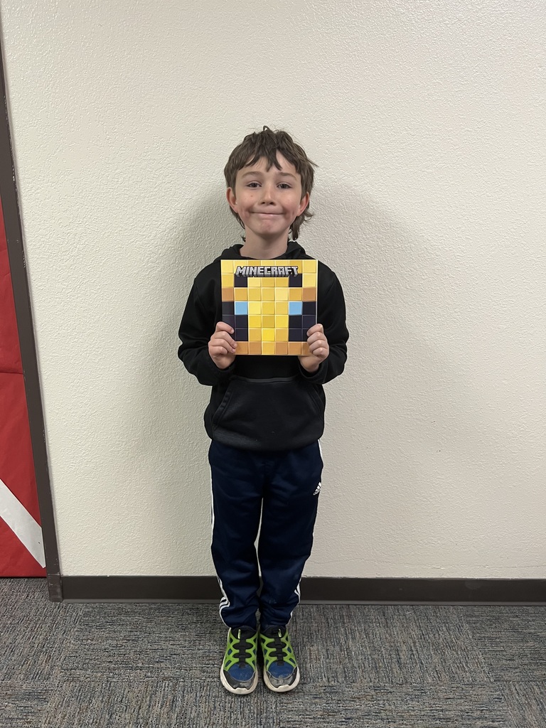 ELEMENTARY STUDENT HOLDING BOOK FOR BEING A GOOD SEED LAST WEEK MAY 2026