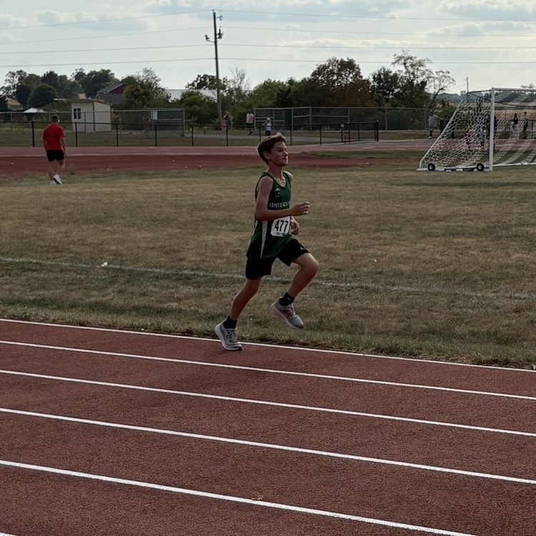 Micah Jordan running towards the finish line