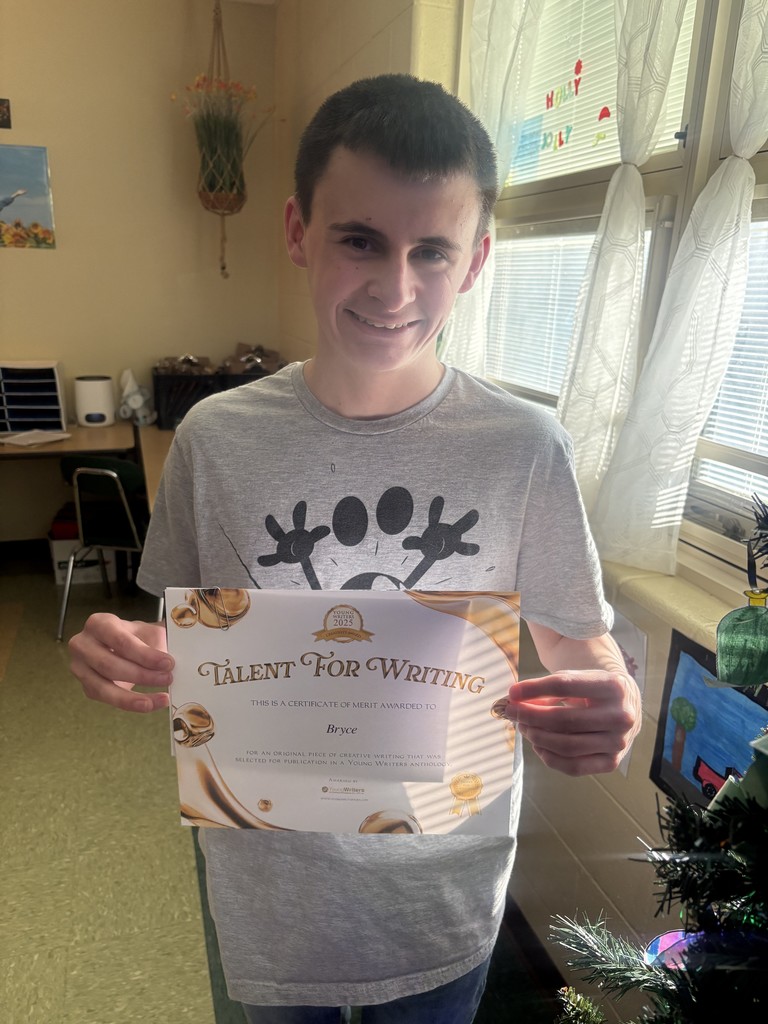 Student displaying their certificate for winning the writing contest. 