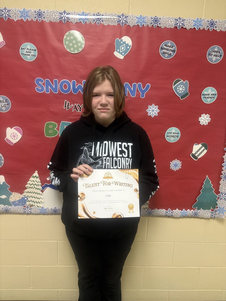Student displaying their certificate for winning the writing contest. 
