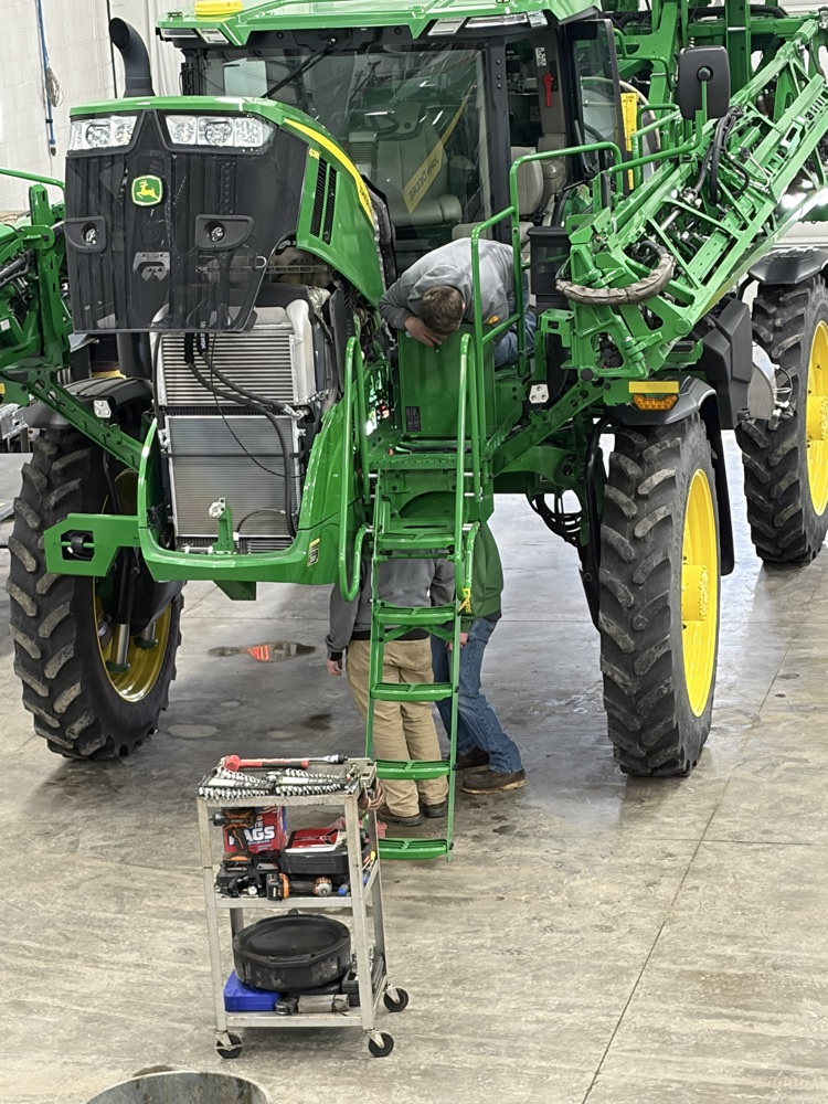 Landon and Wyatt working on equipment 