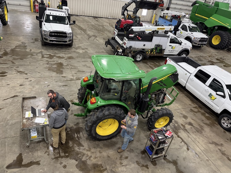 Landon and Wyatt working on equipment