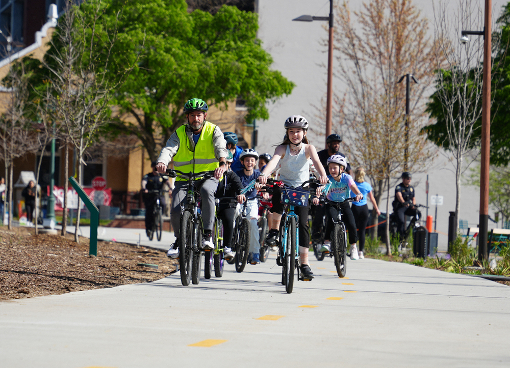 Washington students riding bikes through downtown Fayetteville on the Upper and Lower Ramble 
