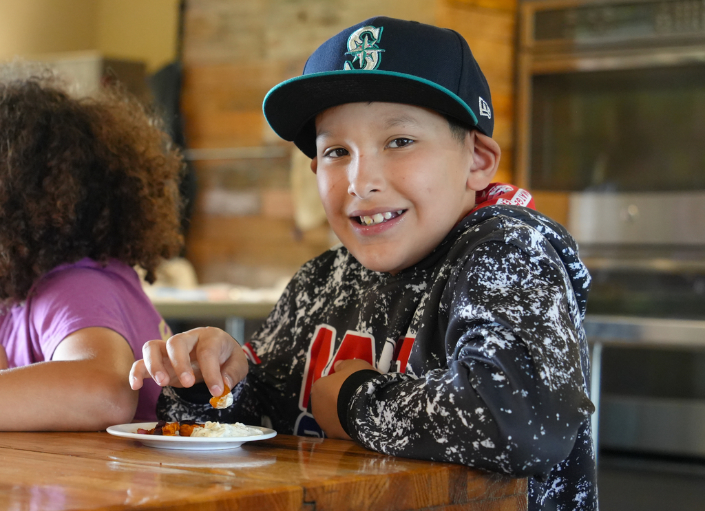 Holcomb 4th grade students work on the Apple Seeds farm picking fresh vegetables and preparing them to eat.