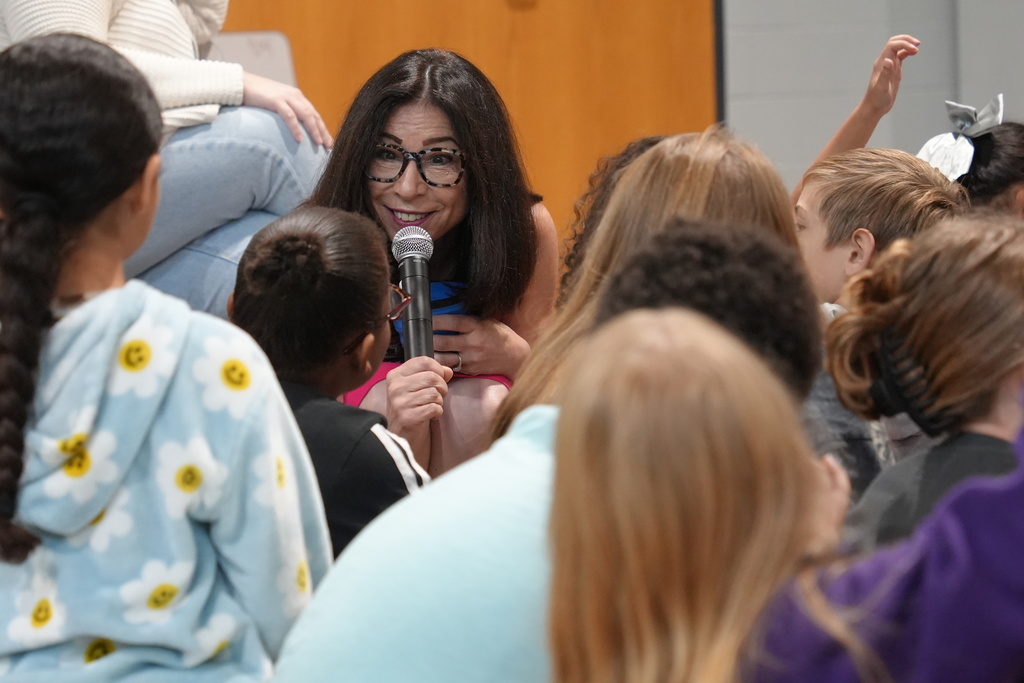 Victoria Coe speaking with students.