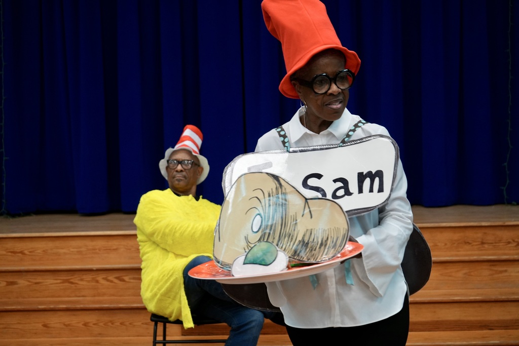 Two people on stage, one in a Sam costume and the other in a Cat in the Hat hat.