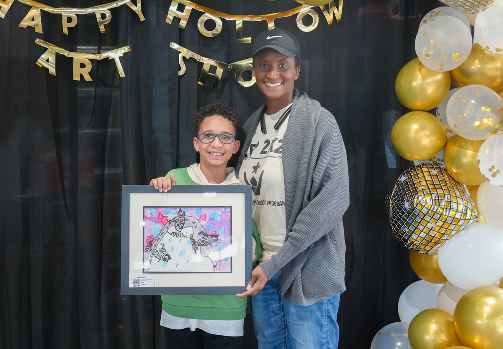 Families participating in activities and viewing student art at the Happy Hollow Art Show.