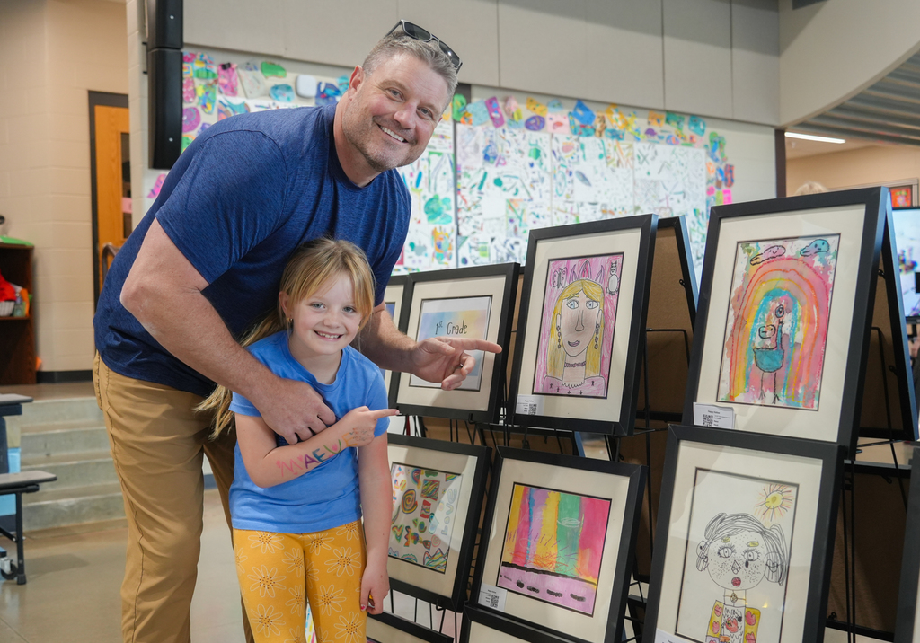 Families participating in activities and viewing student art at the Happy Hollow Art Show.