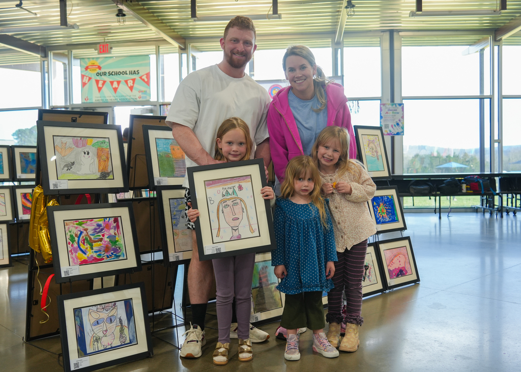 Families participating in activities and viewing student art at the Happy Hollow Art Show.