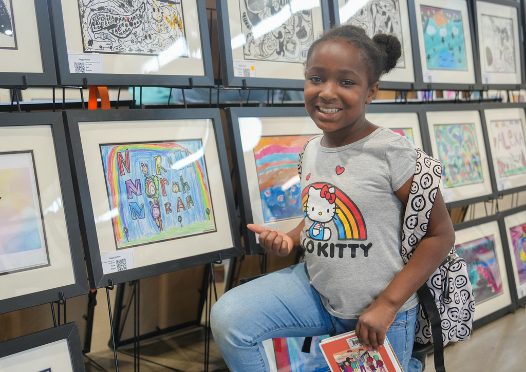 Families participating in activities and viewing student art at the Happy Hollow Art Show.