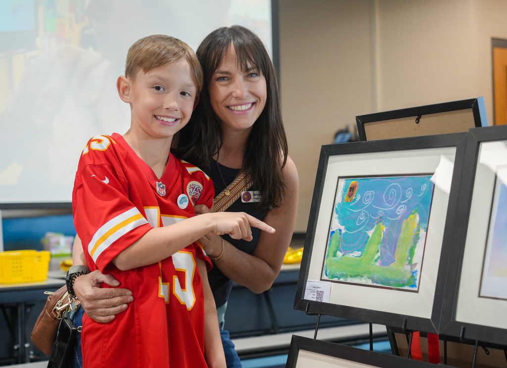 Families participating in activities and viewing student art at the Happy Hollow Art Show.